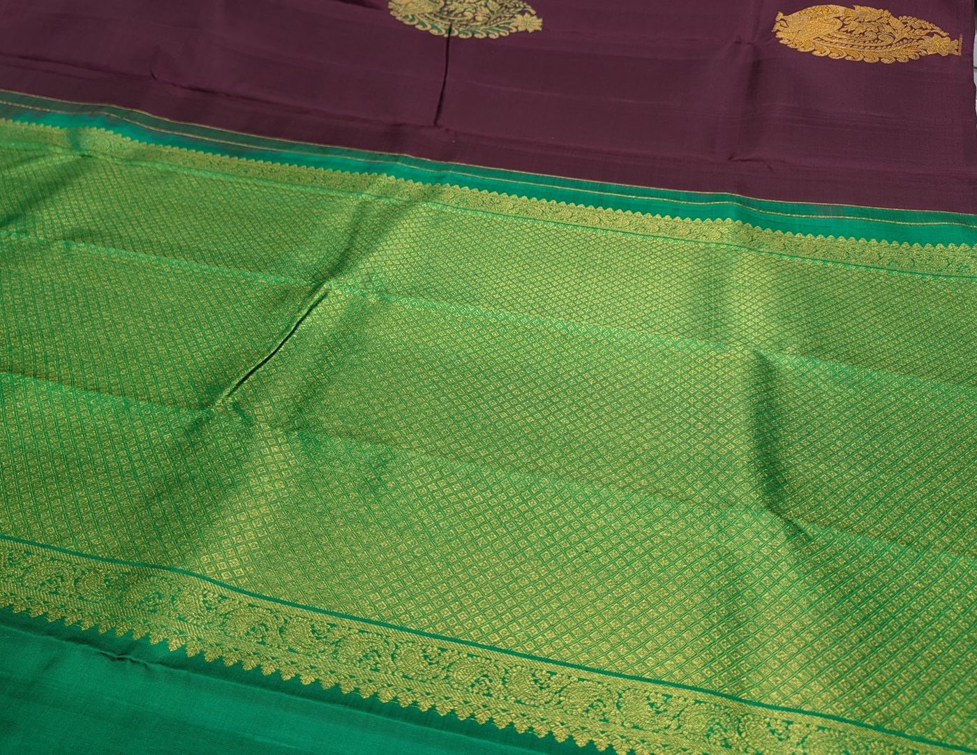 Zari pallu of a wine and green Kanjivaram silk saree